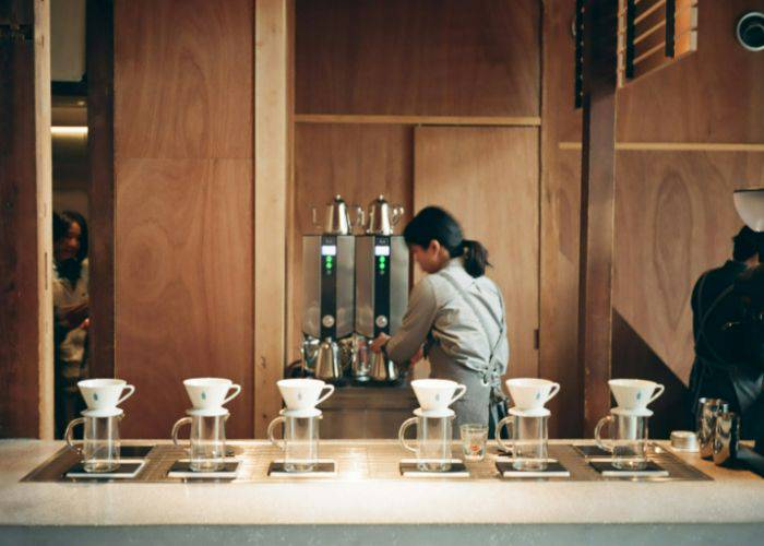 The warm, stylish interior of Blue Bottle Studio Kyoto.